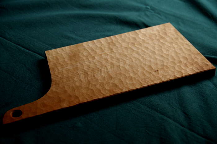 ブラックチェリー材で制作した丸ノミで彫った木製カッティングボード取っ手付き